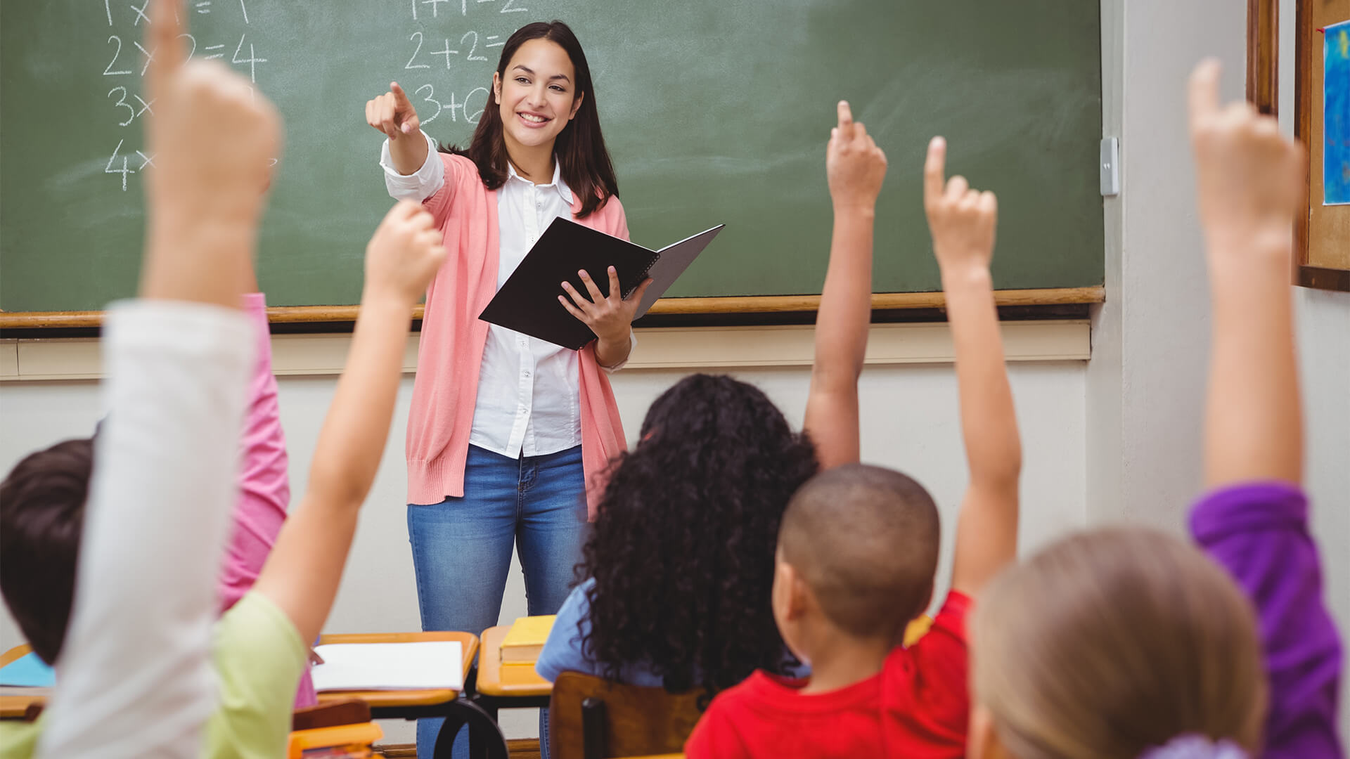 woman teaching class of children
