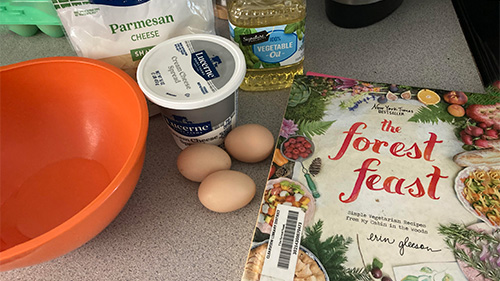 Ingredients and book for Cream Cheese-filled Parmesan Poppers