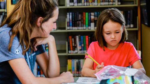 Woman Tutoring Girl