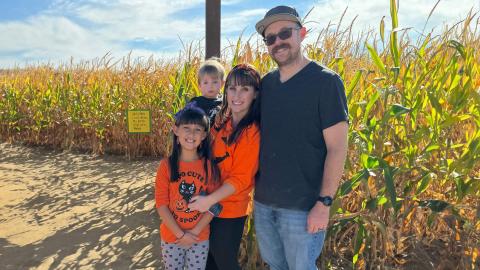 Familt standing in corn field