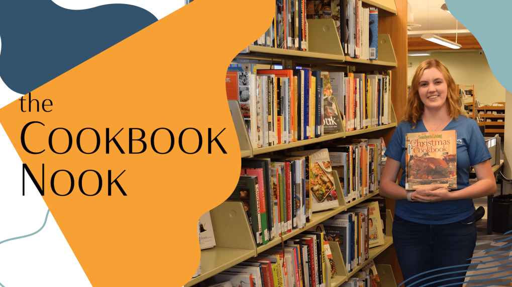 woman holding a cookbook in a library