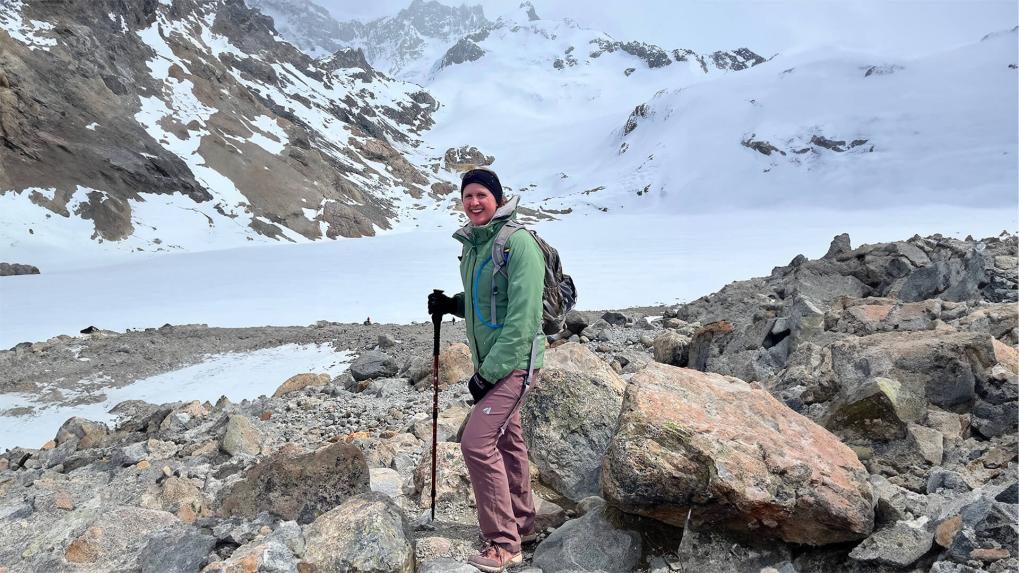 Woman hiking a snow cover mountain