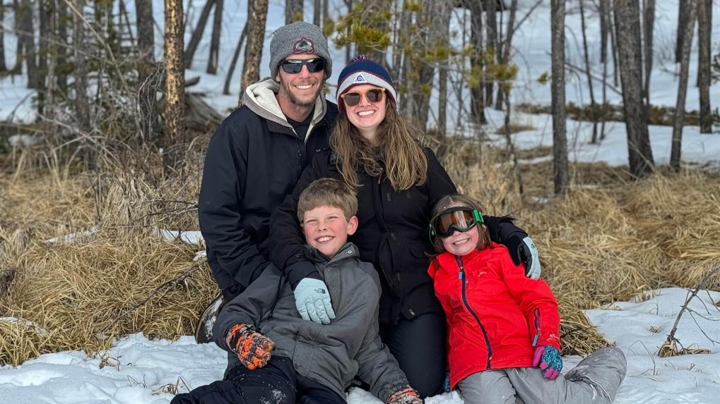 Family sitting in snow