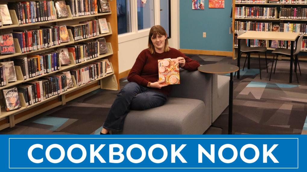 woman in library holding a book