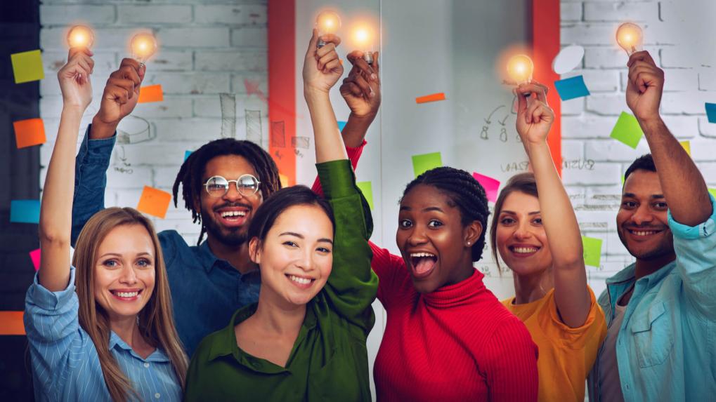 Business team, each holding glowing lightbulbs symbolizing collaboration and ideas.