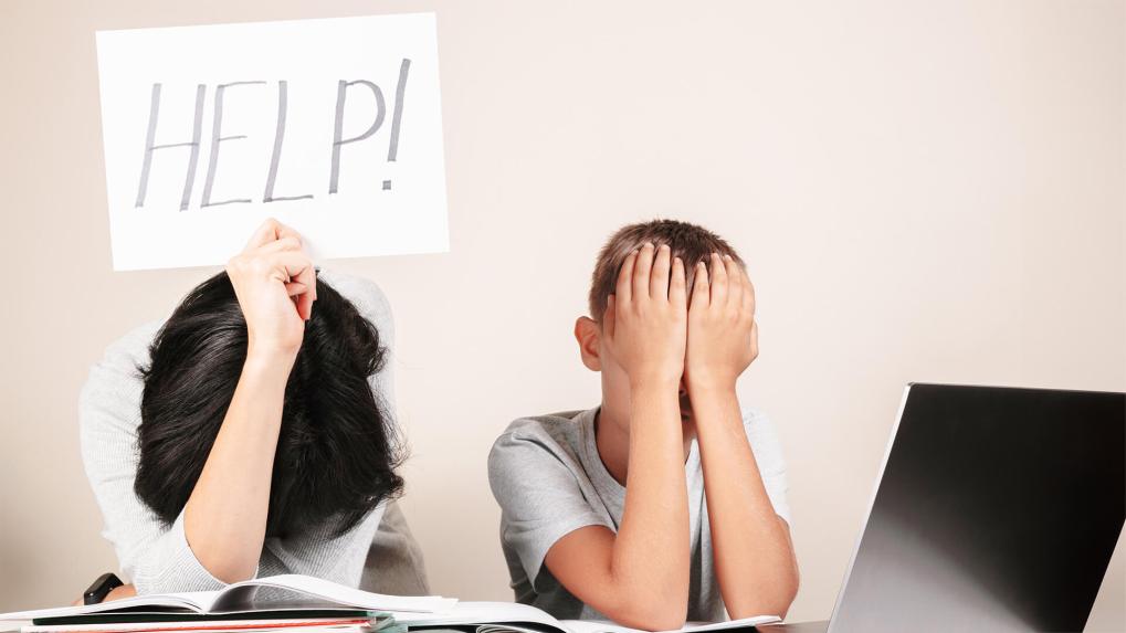 Mom and child with help sign while doing homework Hoomework Helpers