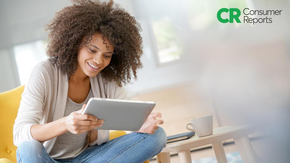 Woman sitting and shopping on a tablet.