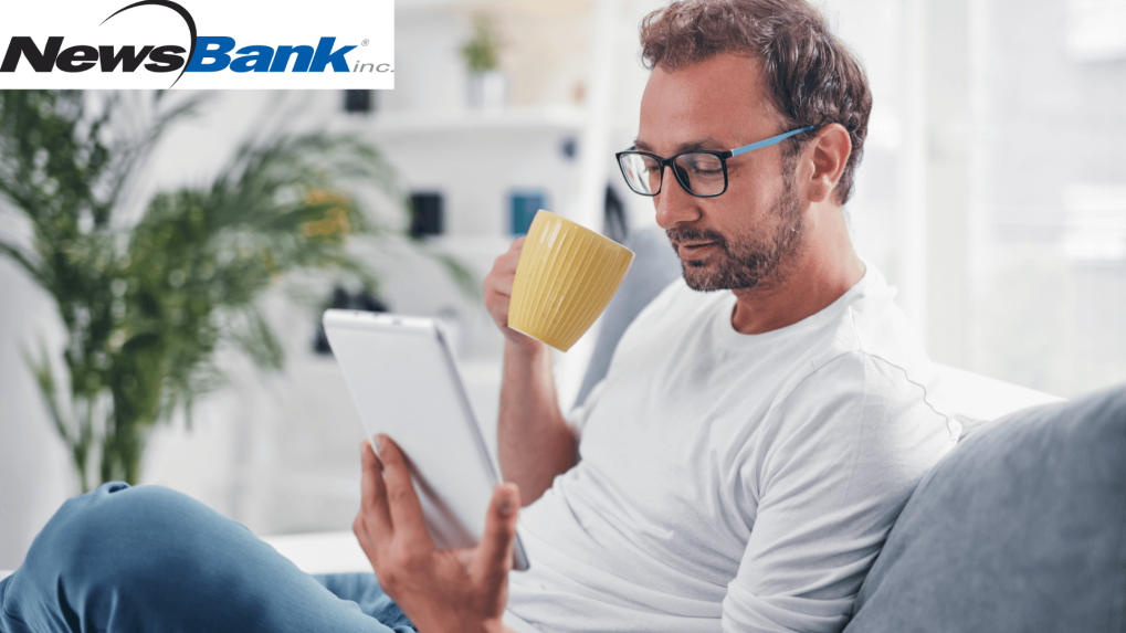 Man reading on a tablet drink a coffee