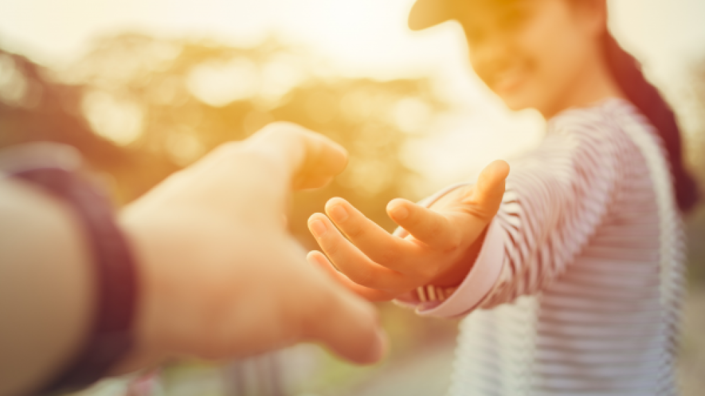 Woman reaching out to another hand