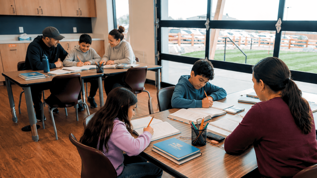 Families working in library on homework