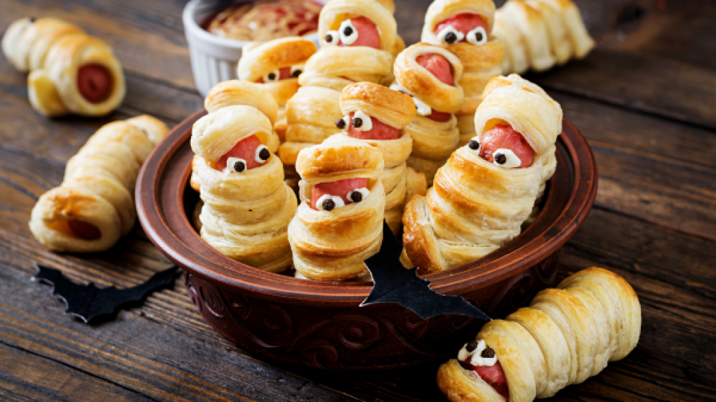 Hot dog rolls with funny eyes on a plate