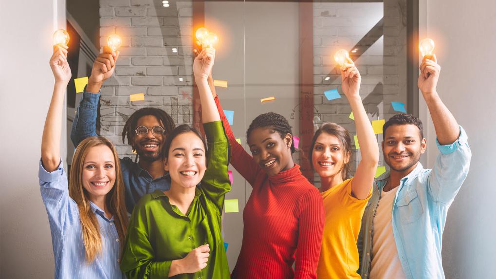 Group of people holding lightbulbs for ideas.